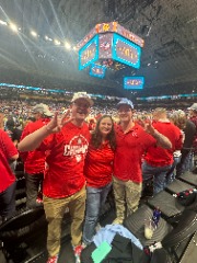 Conrad’s wife, Kristy, with their sons, Tyler (left) and Nathan at the 2025 NCAA Men’s Basketball Final Four inside the Alamodome in San Antonio, Texas. As Conrad remarked, “The best of both my worlds in one photo.”